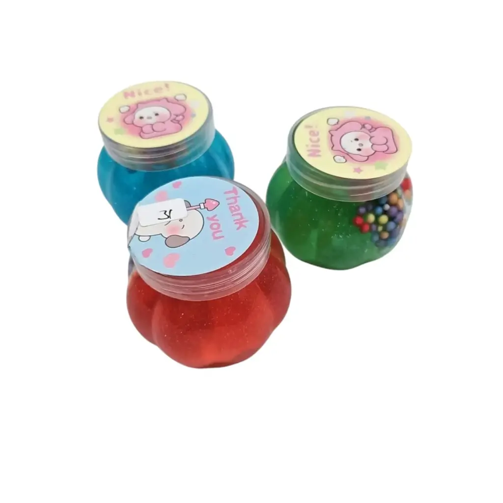 [IX2503360] Kids Playing Glittered Thermo Balls Slime In Pumpkin Shaped Jar